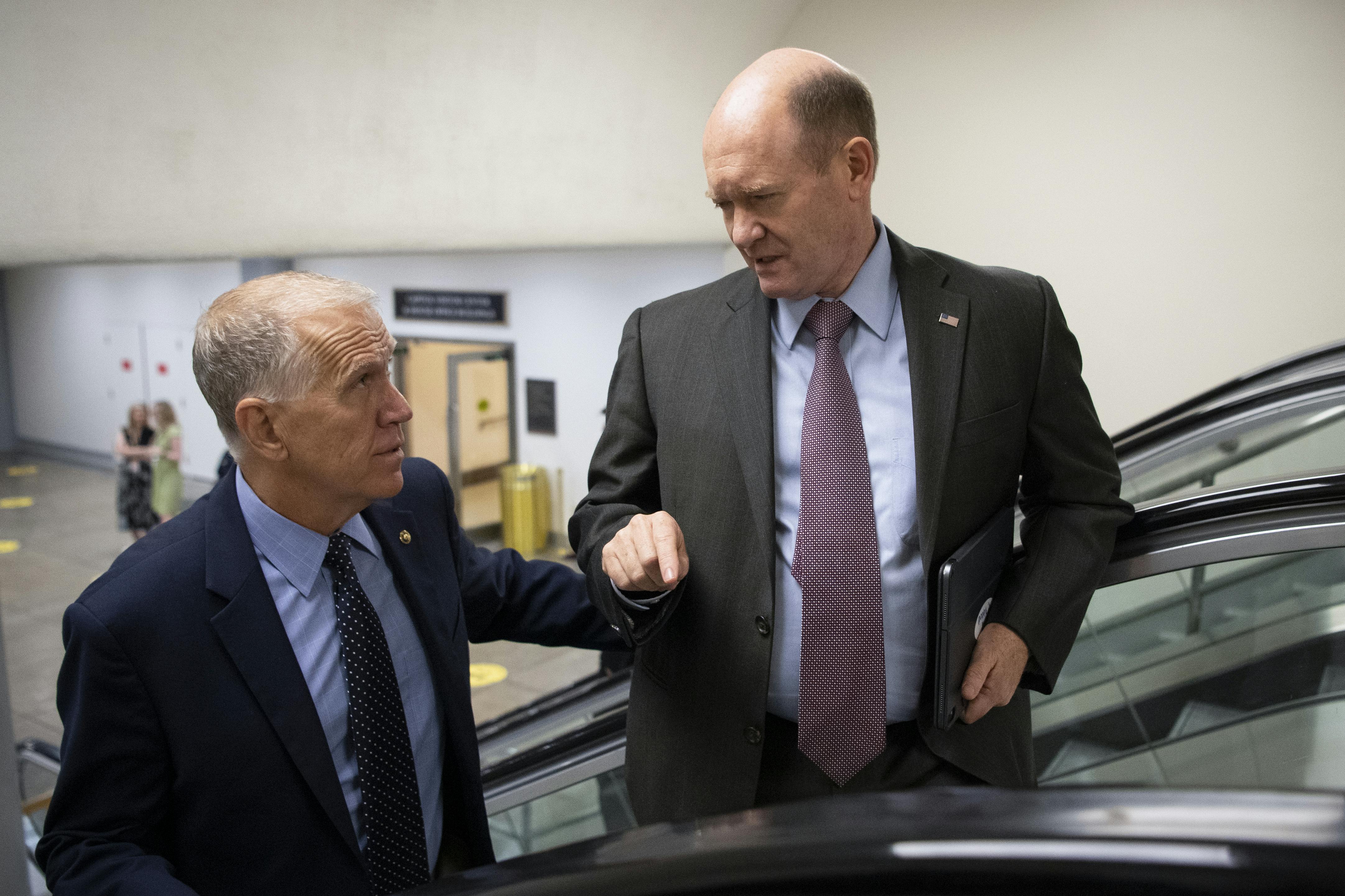 UNITED STATES - May 27: Sen. Thom Tillis, R-N.C., left, and Sen. Chris Coons, D-Del., talk as they make their way to the Senate floor for a vote in the Capitol.