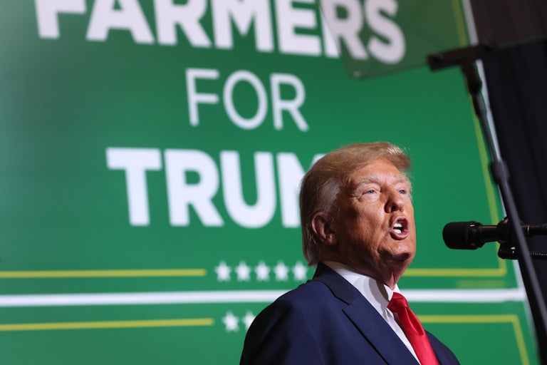 Trump speaks in front of a green sign reading "Farmers for Trump"