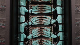 This picture shows bundles of wires connected to a supercomputer.