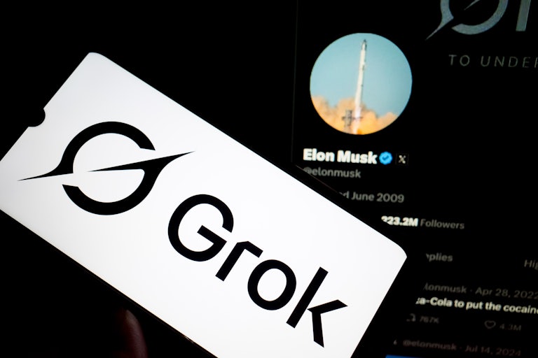 Grok logo on a phone, Elon Musk's X account in the background