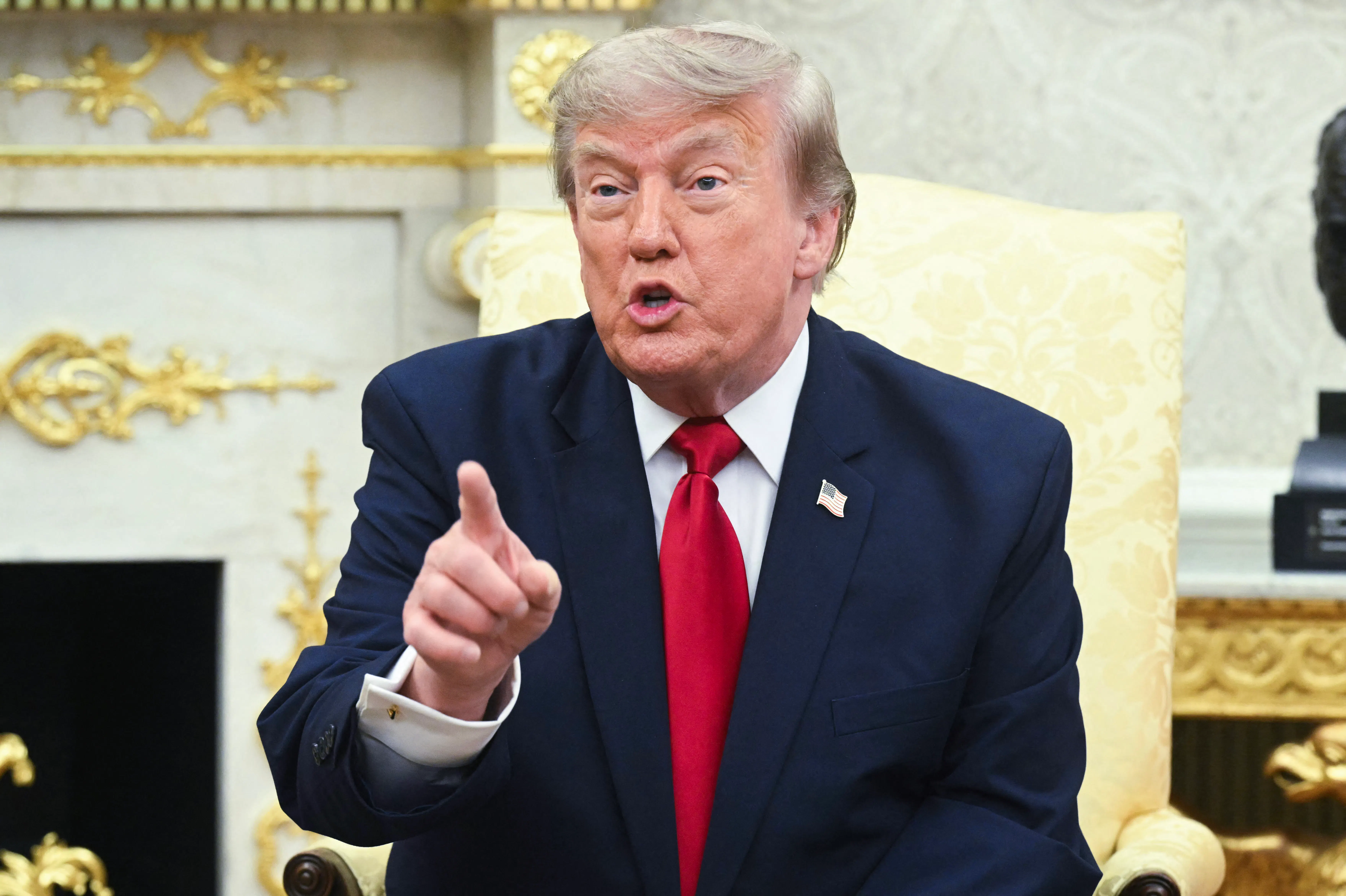 Donald Trump angrily points a finger while talking