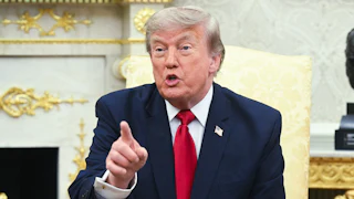 Donald Trump angrily points a finger while talking