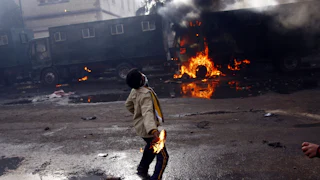 A demonstrator clashes with police in Suez, Egypt