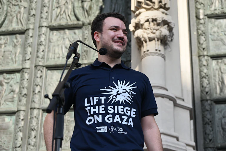 Palestinian activist Mahmoud Khalil wears a shirt that says "Lift the Siege on Gaza."