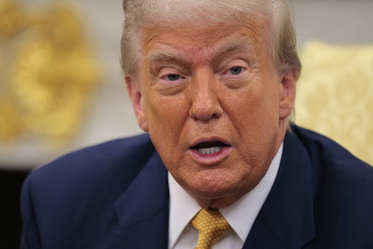 Donald Trump speaks while sitting in the Oval Office