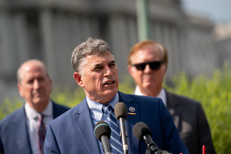 Representative Andrew Clyde speaks into microphones outside the U.S. Capitol