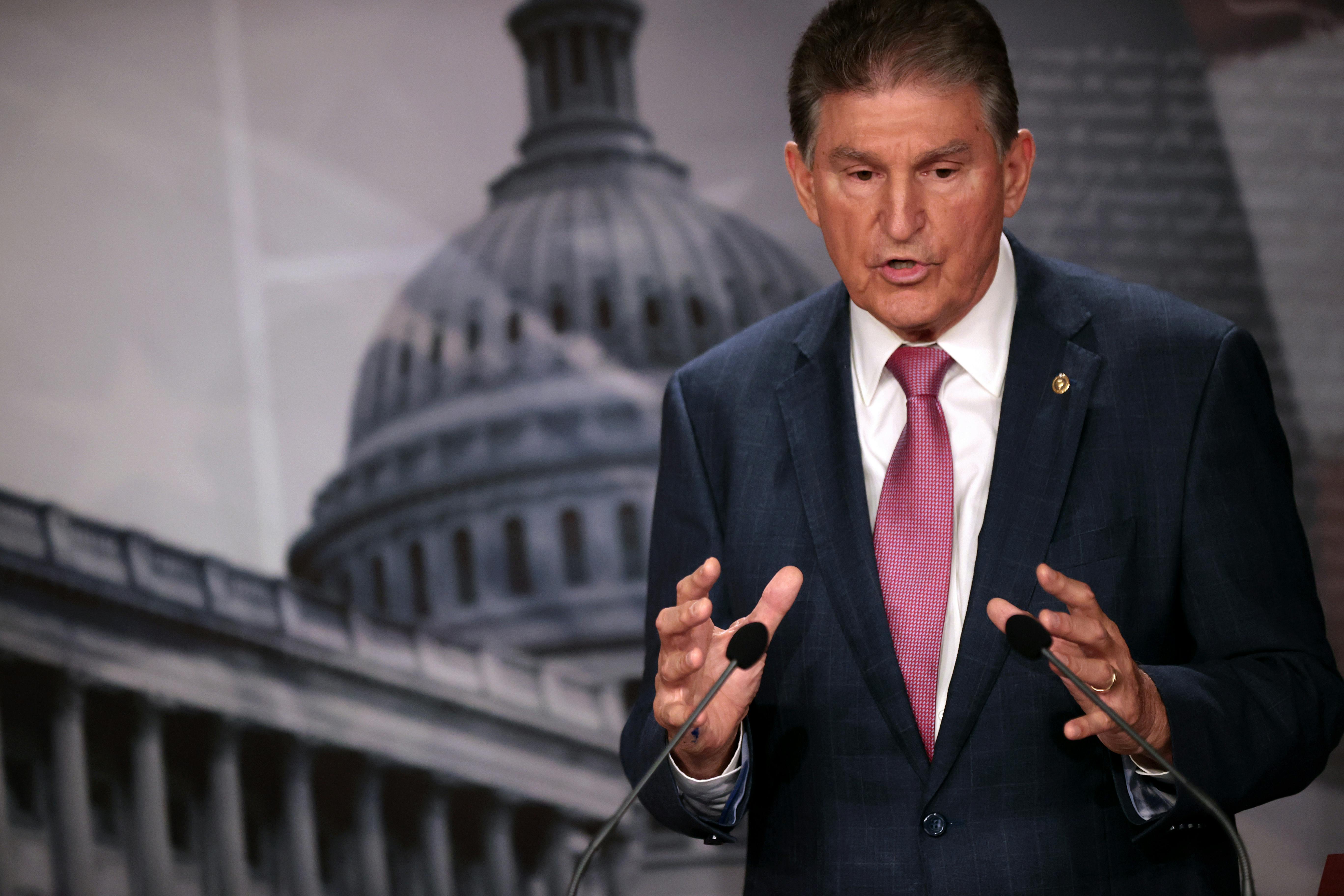 West Virginia Senator Joe Manchin gestures as he speaks to reporters.