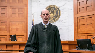 District Court Judge James Boasberg wearing a judge's robe and standing in court.