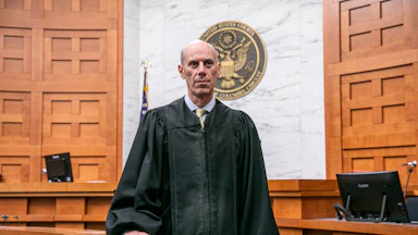 District Court Judge James Boasberg wearing a judge's robe and standing in court.