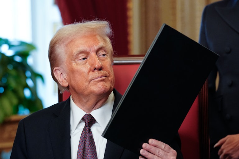 Donald Trump hands over an executive order