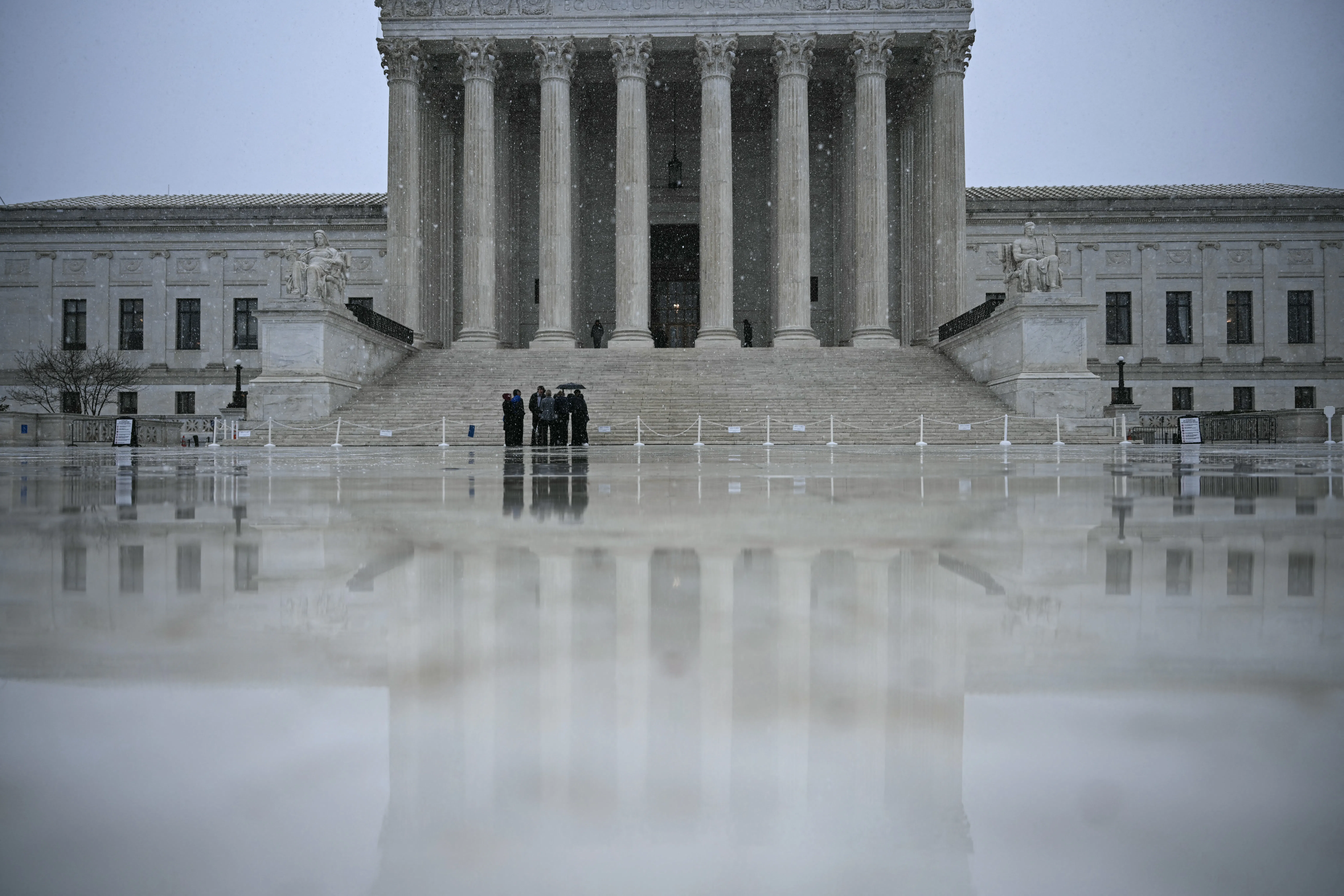 Snow flurries fall outisde the US Supreme Court in Washington, DC, on March 12, 2026. 