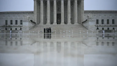 Snow flurries fall outisde the US Supreme Court in Washington, DC, on March 12, 2026.