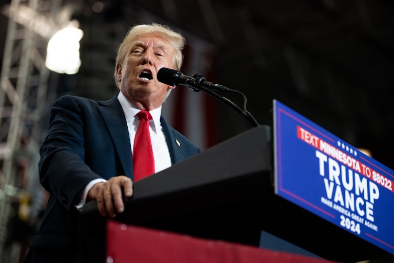 Donald Trump speaks into a mic