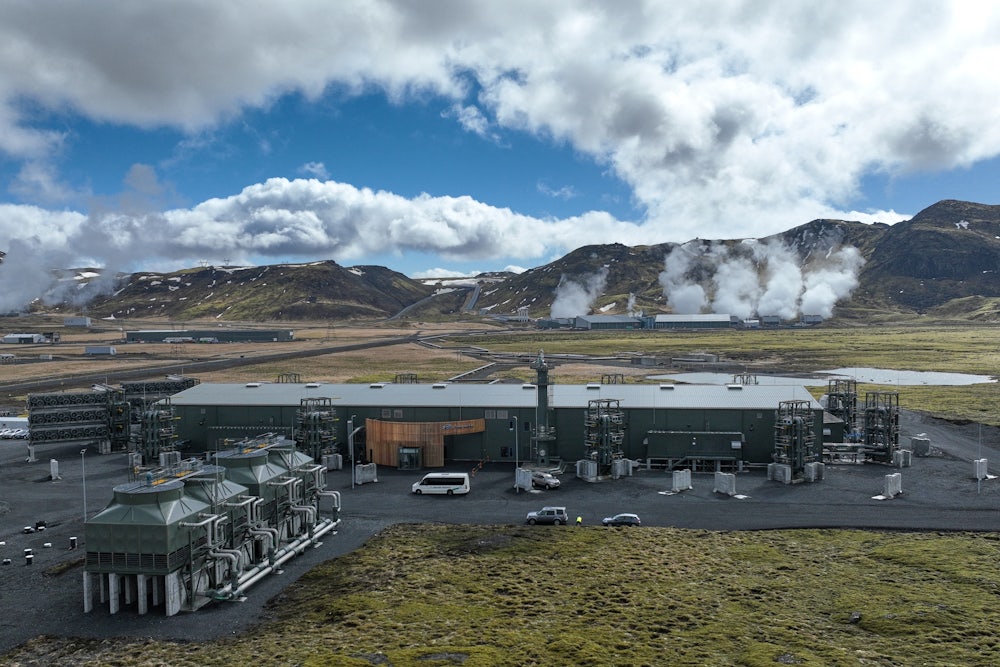 The Mammoth facility by Climeworks sits in the middle of the tundra with mountains in the background.