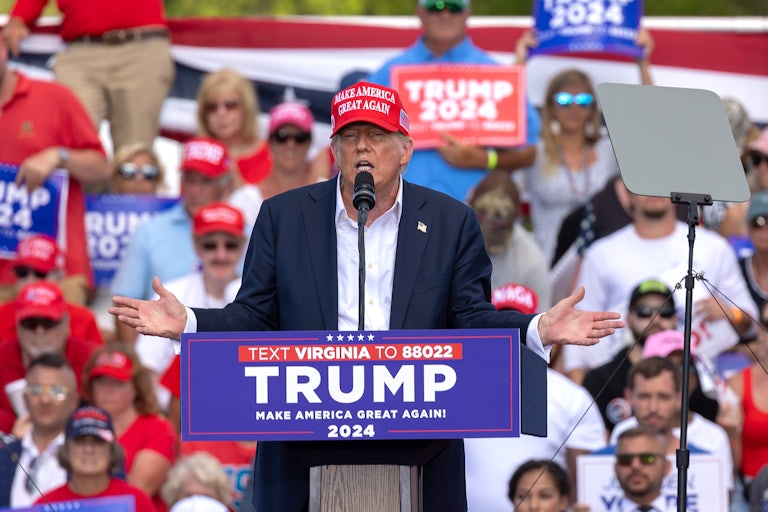 Donald Trump gestures as he speaks at a podium