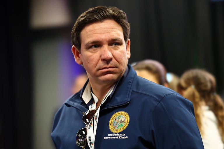 Ron DeSantis stares ahead while wearing a jacket