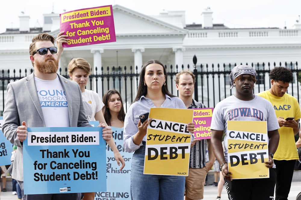 Demonstrators hold signs reading "CANCEL STUDENT DEBT" and "President Biden: Thank You for Canceling Student Debt."