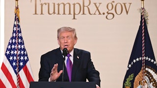 Donald Trump speaks at a podium with the TrumpRx website behind him.
