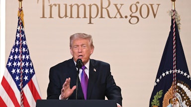 Donald Trump speaks at a podium with the TrumpRx website behind him.