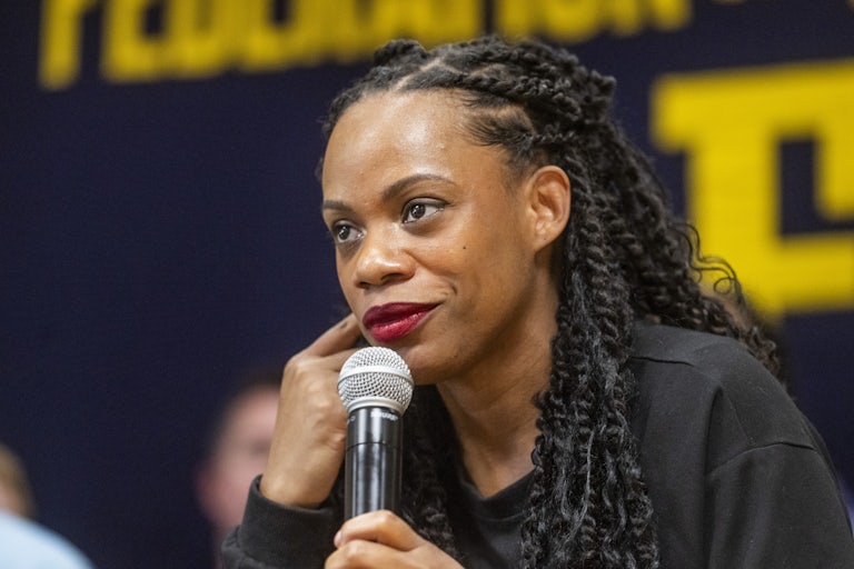 Summer Lee holds a microphone to her face