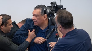 Multiple men push Democratic Senator Alex Padilla out of Homeland Security Secretary Kristi Noem's press conference. A cameraman captures it all.