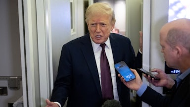 Donald Trump speaks to reporters aboard Air Force One