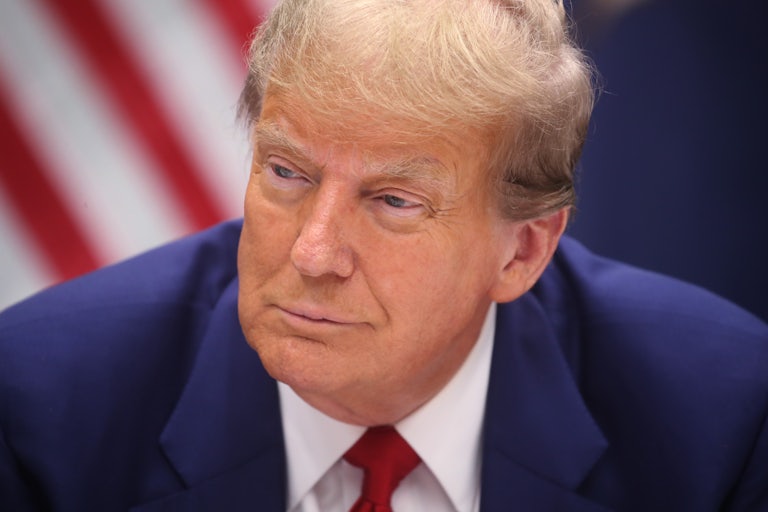 Donald Trump smiles as he looks off-camera