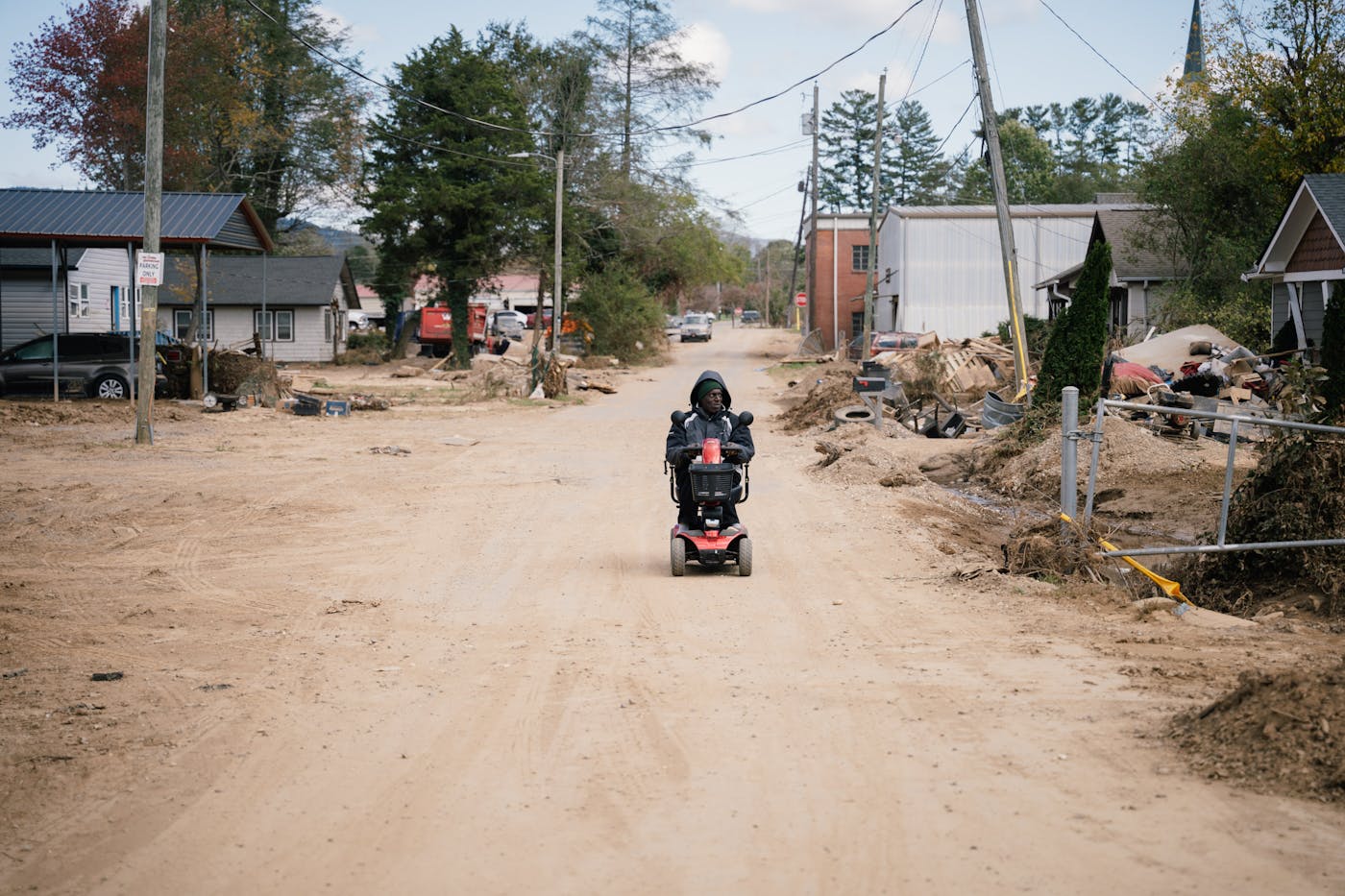 In an effort to pick up his medication at a nearby CVS, Swannanoa resident Carl Jones Sr. rode his mobility scooter down a debris- and dust-covered street.