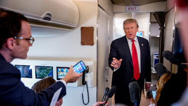Donald Trump speaking to reporters aboard Air Force One