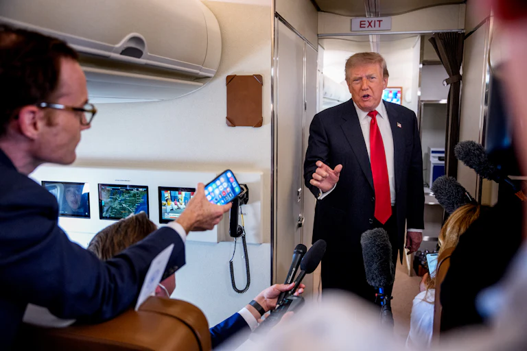 Donald Trump speaking to reporters aboard Air Force One