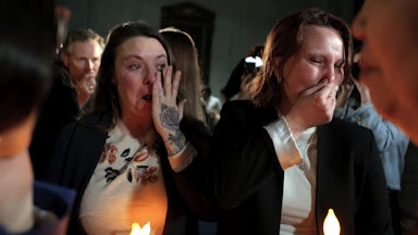 Epstein survivors cry and wipe their tears.