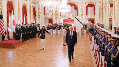 Donald Trump walks away from Japanese Prime Minister Sanae Takaichi as Japanese troops are lined up to greet them during a welcoming ceremony at Akasaka Palace.