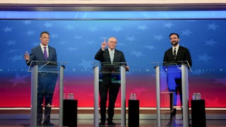 Andrew Cuomo, Curtis Sliwa, and Zohran Mamdani stand at podiums onstage during the New York City mayoral debate