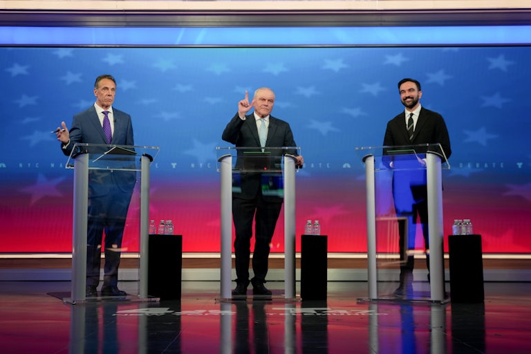Andrew Cuomo, Curtis Sliwa, and Zohran Mamdani stand at podiums onstage during the New York City mayoral debate
