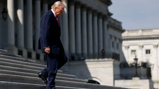 Donald Trump walks down steps outside the Capitol