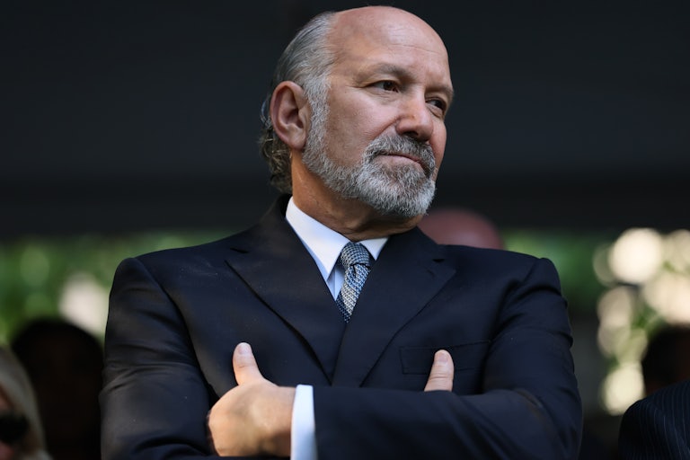 Commerce Secretary Howard Lutnick looks to the side while standing with his arms crossed over his chest