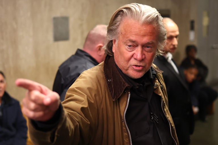 Steve Bannon speaks and points a finger at someone off camera