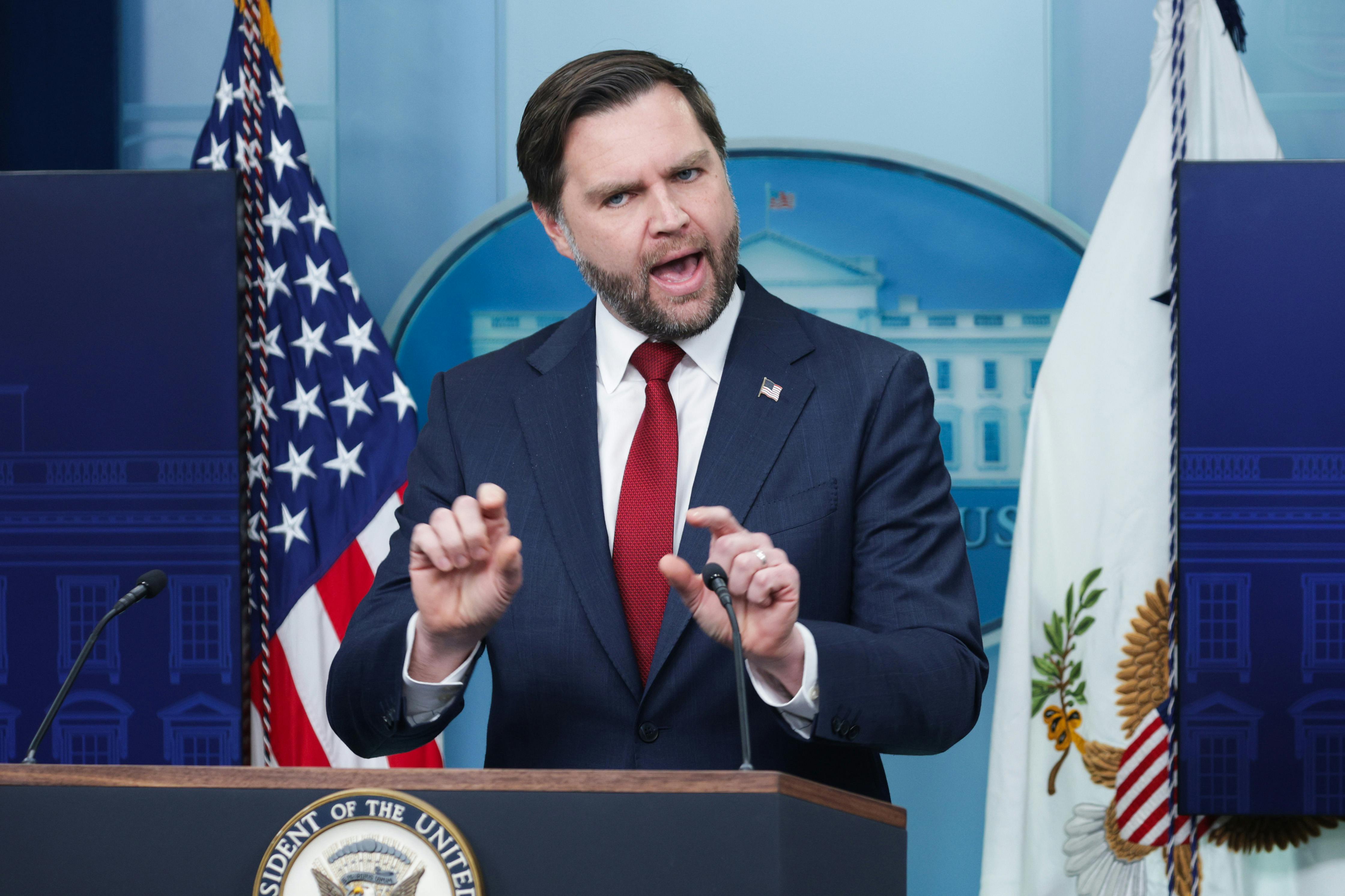Vice President JD Vance gestures and speaks at the podium of the White House press briefing room