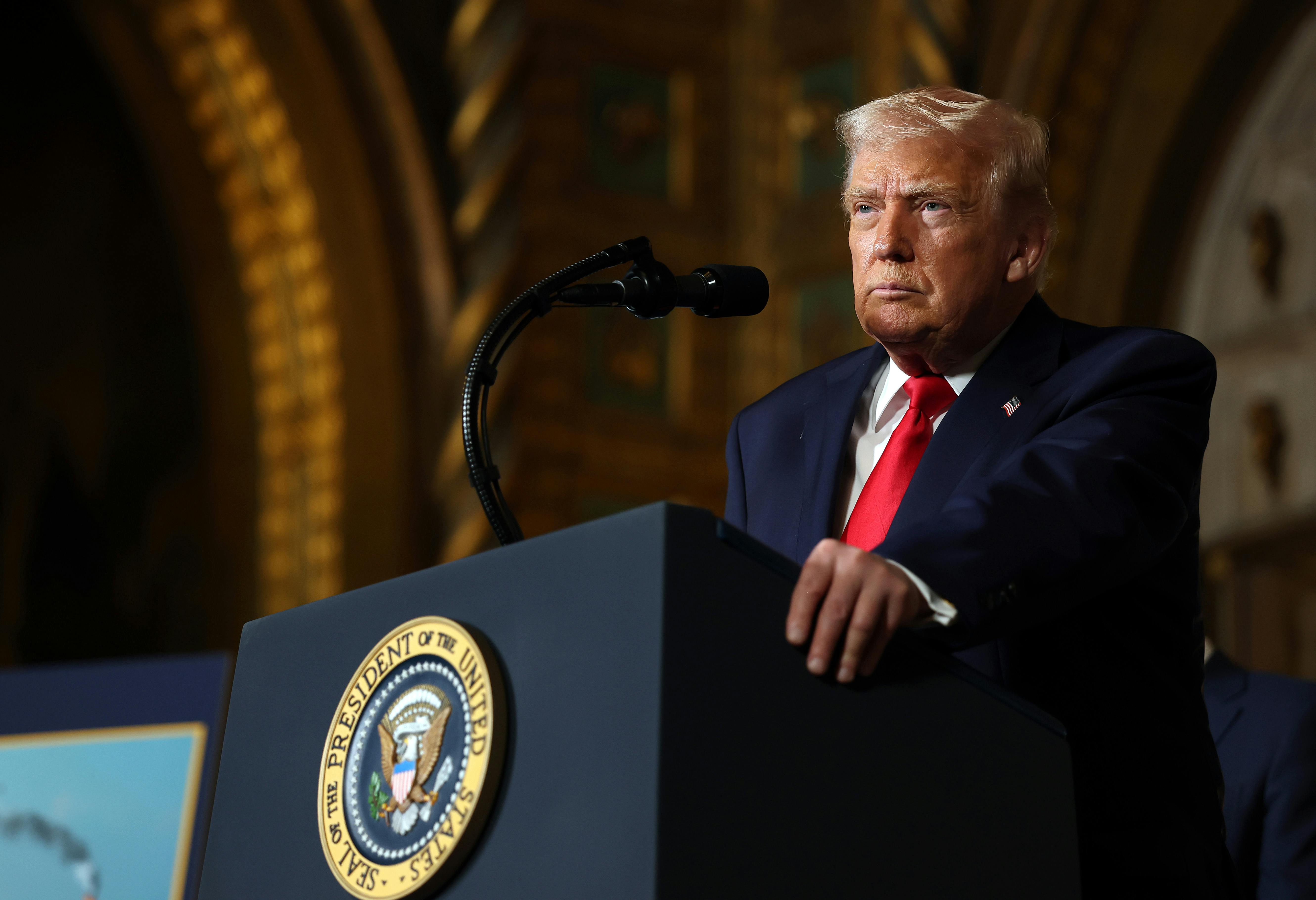 Donald Trump stands at a podium