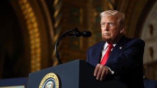 Donald Trump stands at a podium