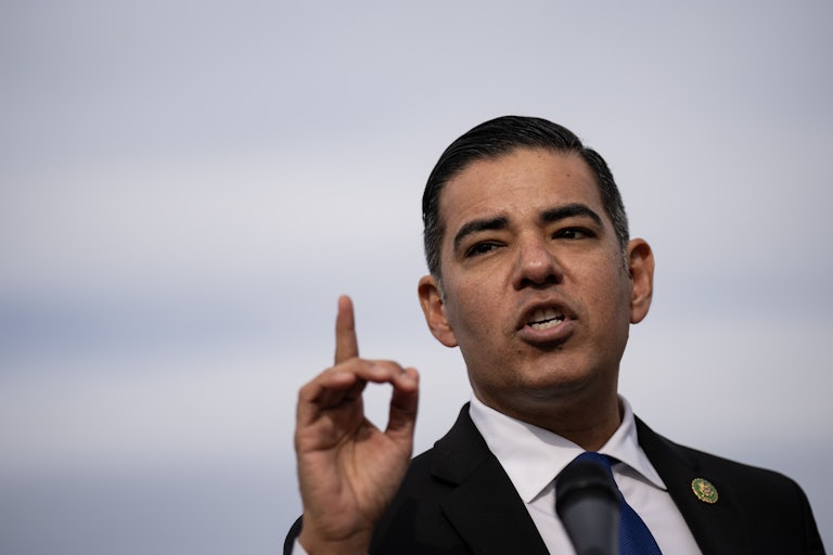 Representative Robert Garcia gestures while speaking to reporters outside the Capitol