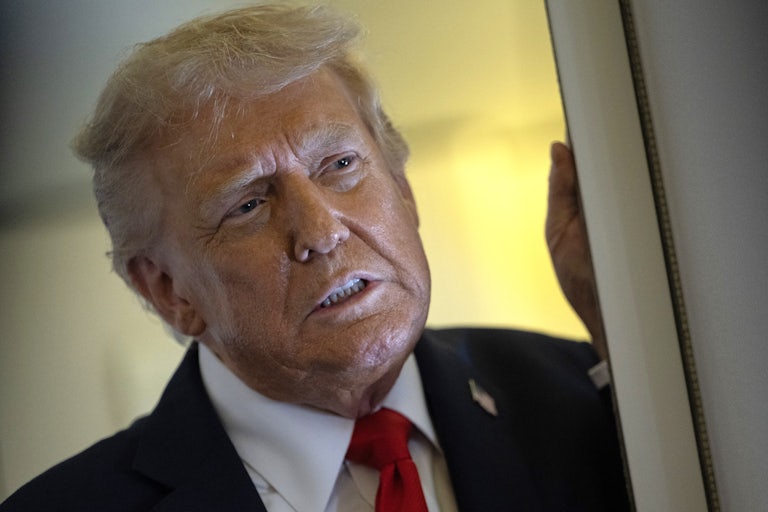 Donald Trump speaks to reporters on Air Force One