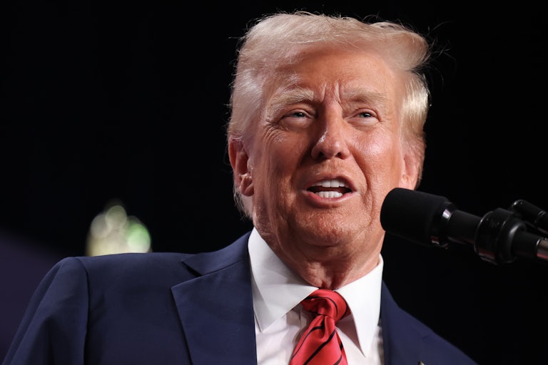 Donald Trump speaks into a mic