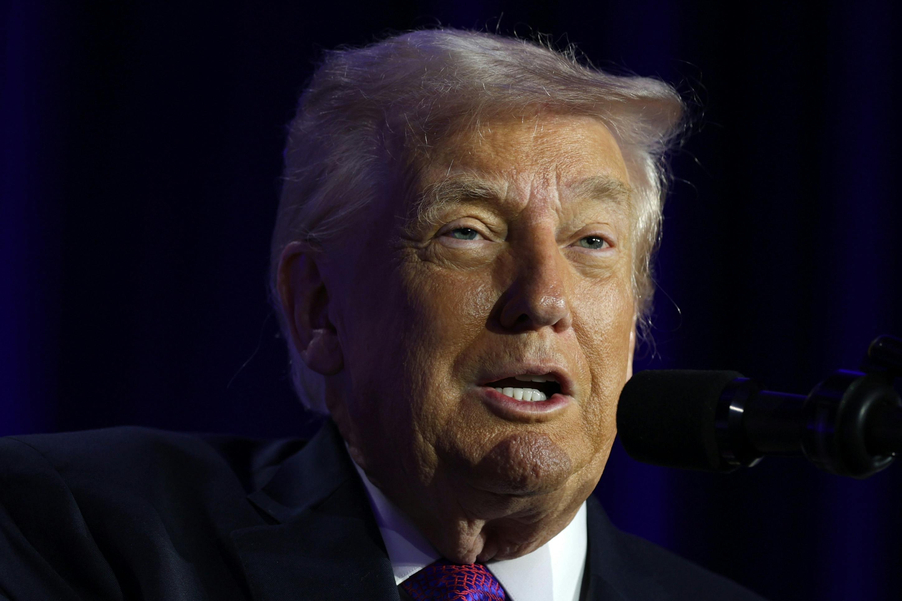 Donald Trump speaks into a microphone