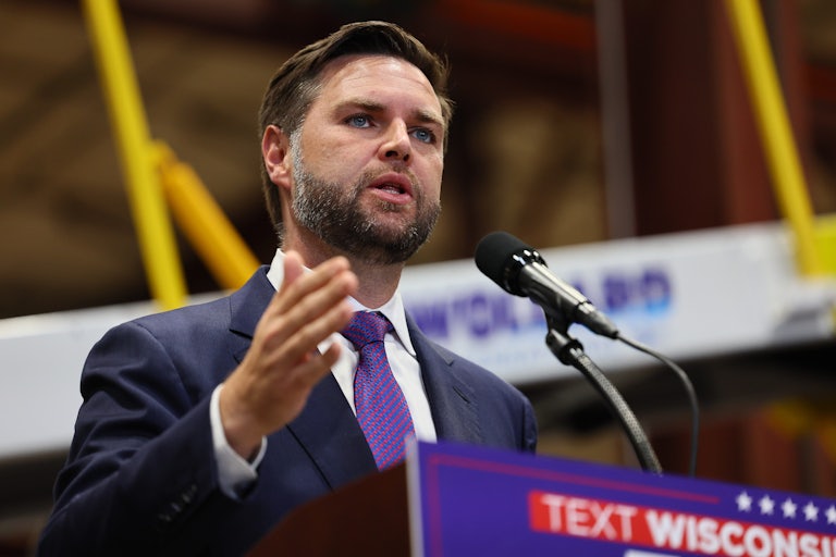 J.D. Vance speaks at a lectern and makes a hand gesture for emphasis