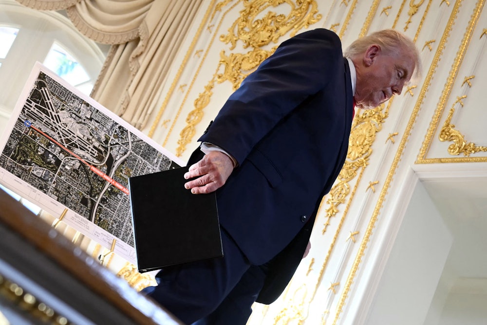 Donald Trump walks off the stage past a map.