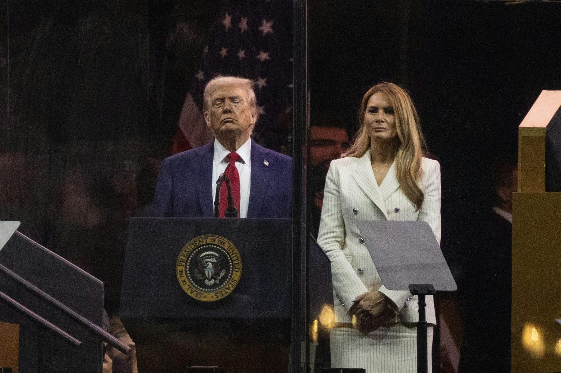 Donald and Melania Trump stand during his birthday parade