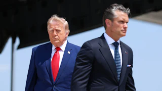 President Donald Trump walks in one direction while Defense Secretary Pete Hegseth walks in the other.