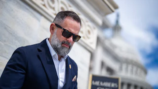 Representative Cory Mills walks down the steps of the Capitol