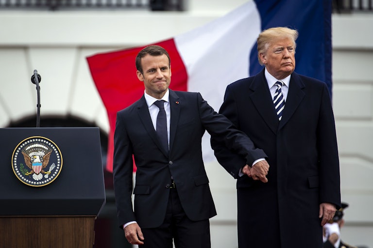 Emmanuel Macron and Donald Trump hold hands